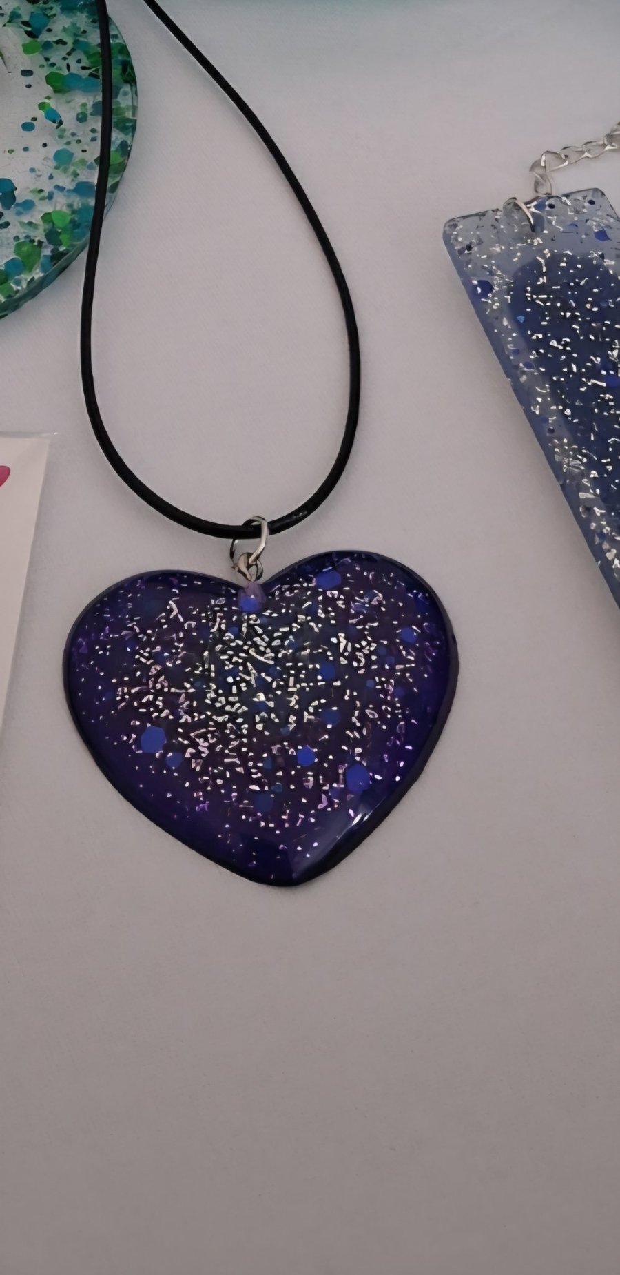 Handmade resin purple glitter heart pendant on  black waxed cord