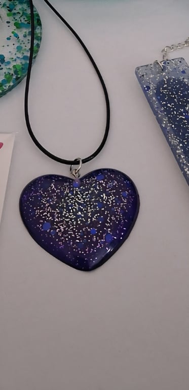 Handmade resin purple glitter heart pendant on  black waxed cord