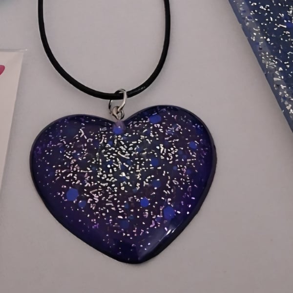 Handmade resin purple glitter heart pendant on  black waxed cord