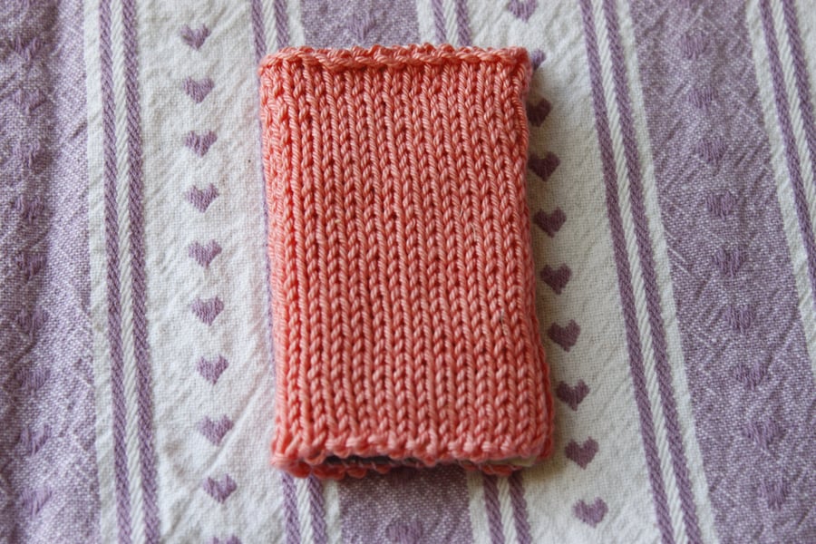 Hand knitted needle case and contents - coral pink