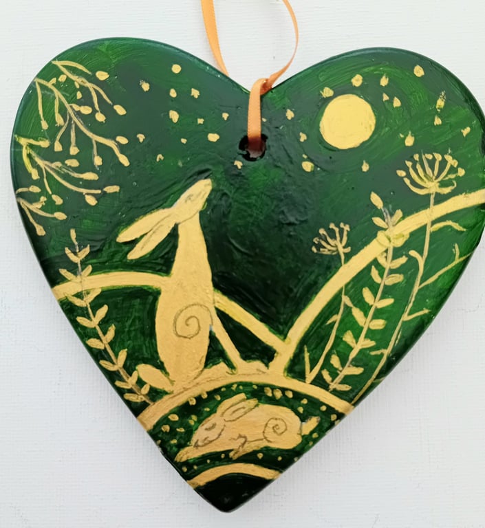 golden hare on a green ceramic heart