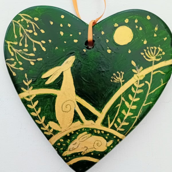 golden hare on a green ceramic heart
