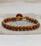 Goldstone and metallic gold leather bracelet with wooden button fastener  - Image 2