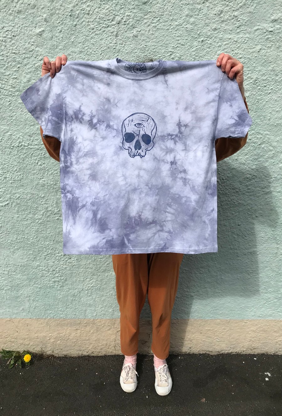 Natural eco dyed, blue tie-dye cotton t-shirt with linocut skull print.