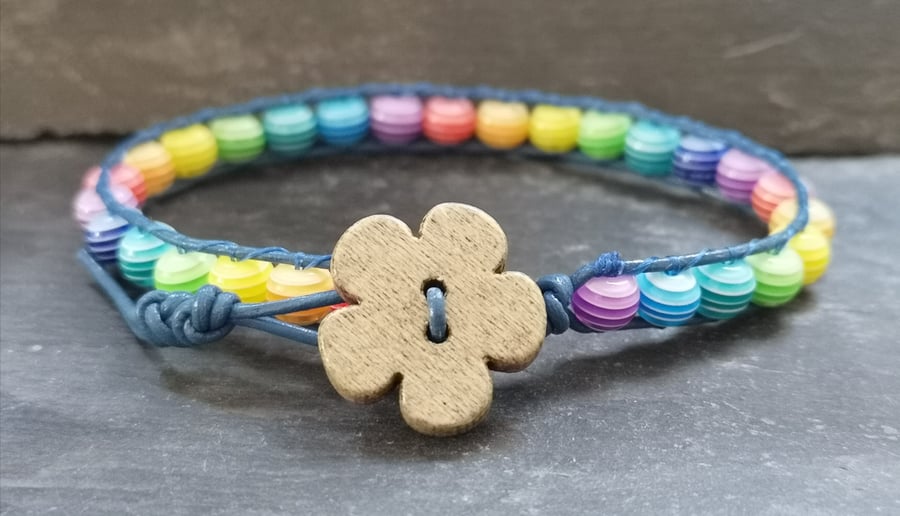 Blue leather bracelet, rainbow striped acrylic beads and wooden flower button 