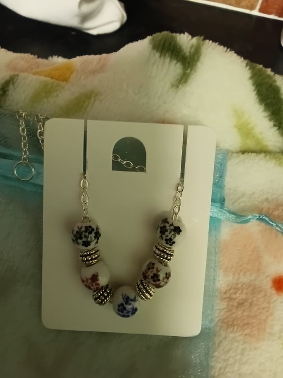 Lovely beaded bracelet with flower details painted on the beads, silver charms, 