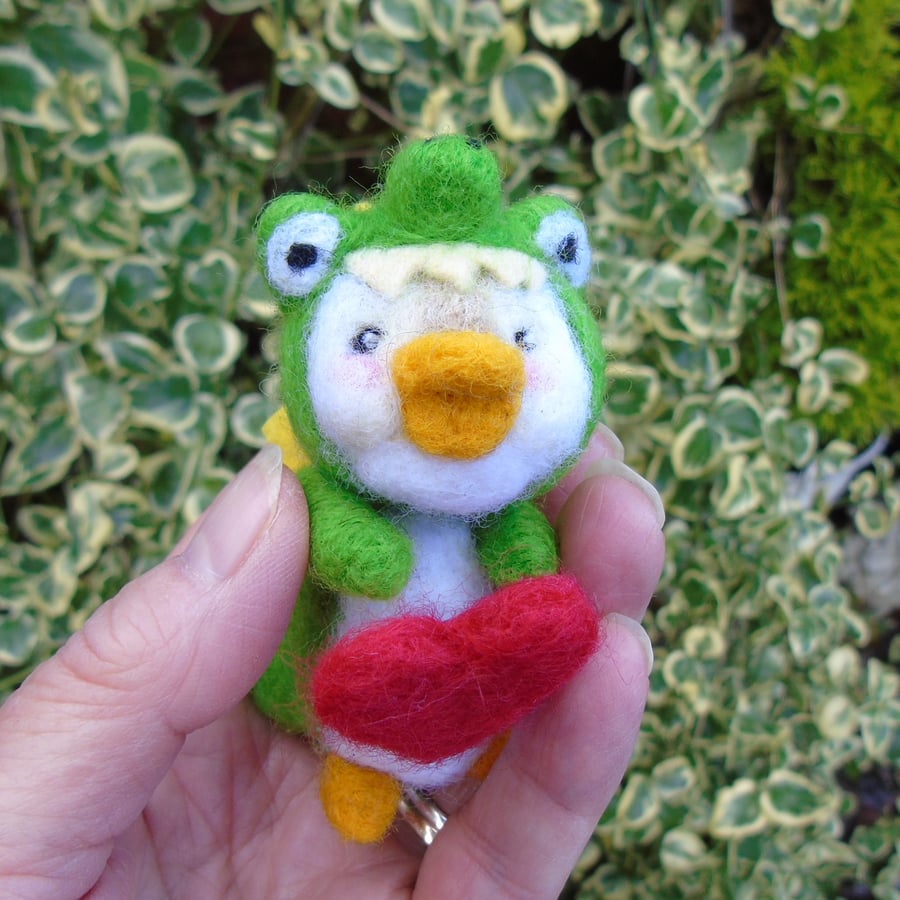 Duck in crocodile costume  holding a red heart needlefelt animal 