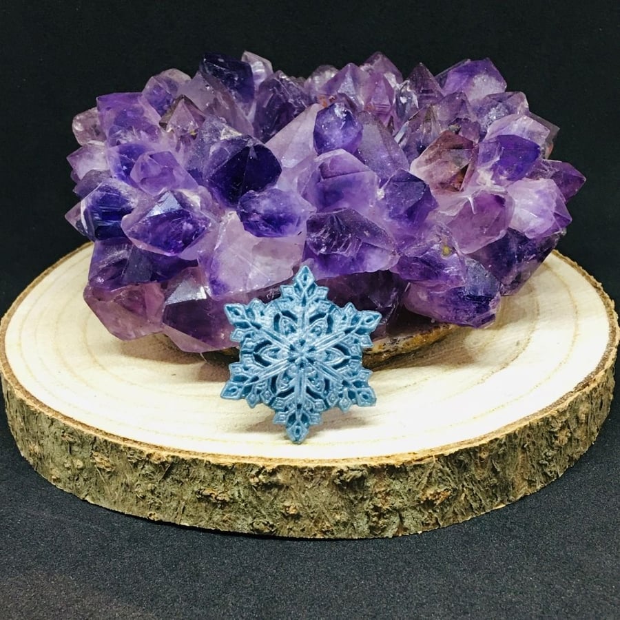 Snowflake silver blue pendant on a sterling silver chain.