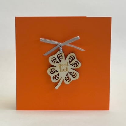 'Good luck' card with detachable decoration