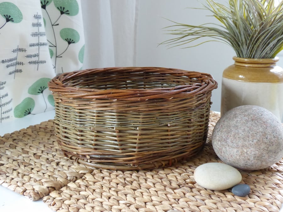 A round handmade willow basket with a Catalan style base.