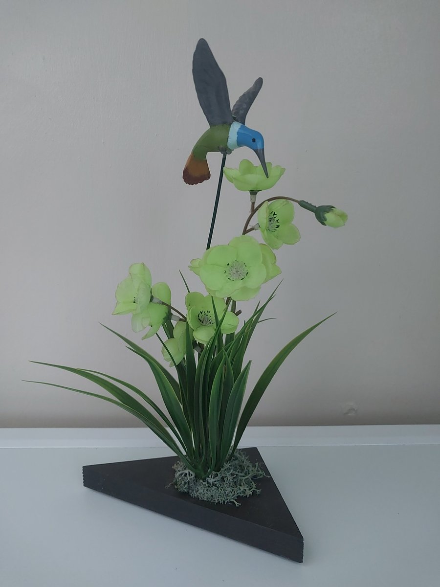 Humming Bird flower arrangement display on wood plinth