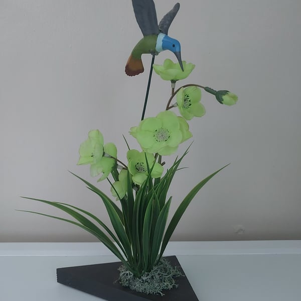 Humming Bird flower arrangement display on wood plinth