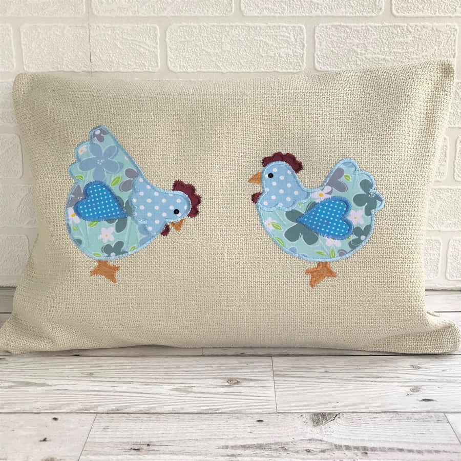 Chickens cushion with two pale blue floral and polka dot chickens