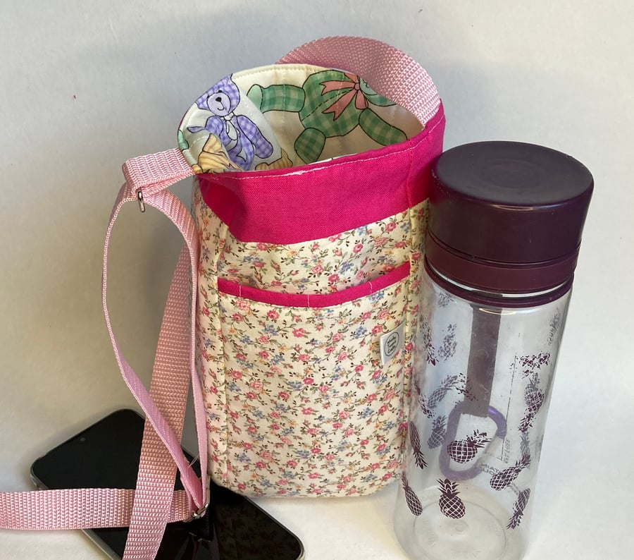 Water bottle carrier with pocket for phone. Floral and teddy prints.