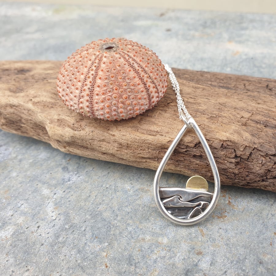 Silver teardrop sun rising over the sea pendant