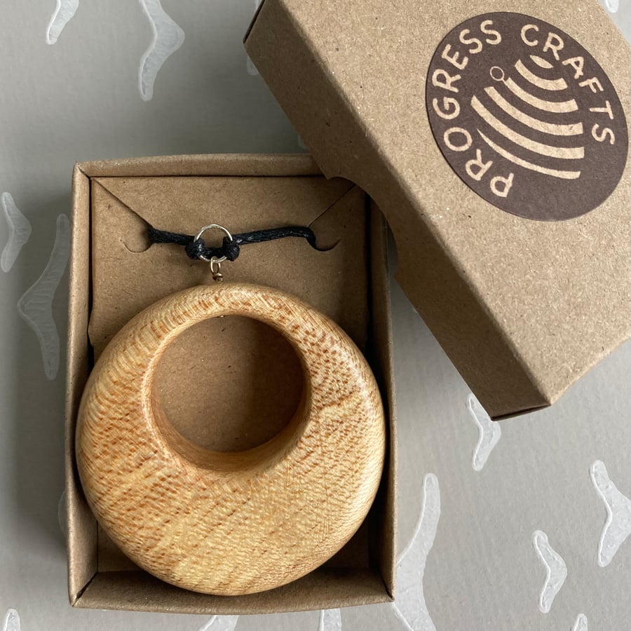 Circular light coloured sycamore pendant