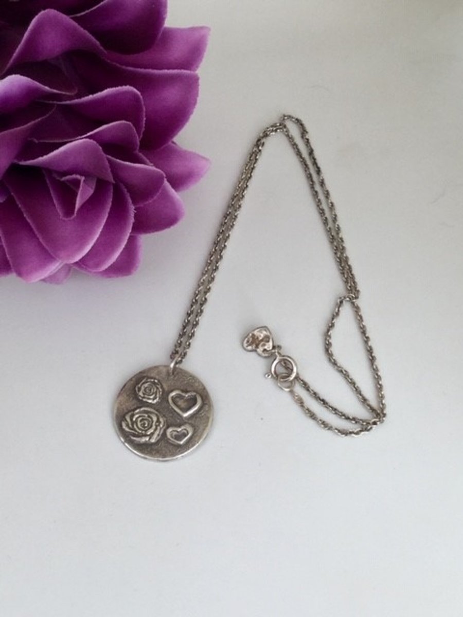 Fine silver pendant with hearts and flowers design on sterling silver chain
