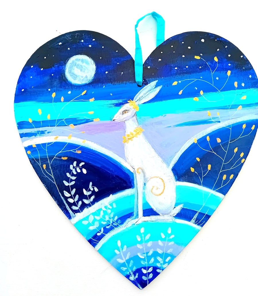 White hare with golden collar on a heart shape 