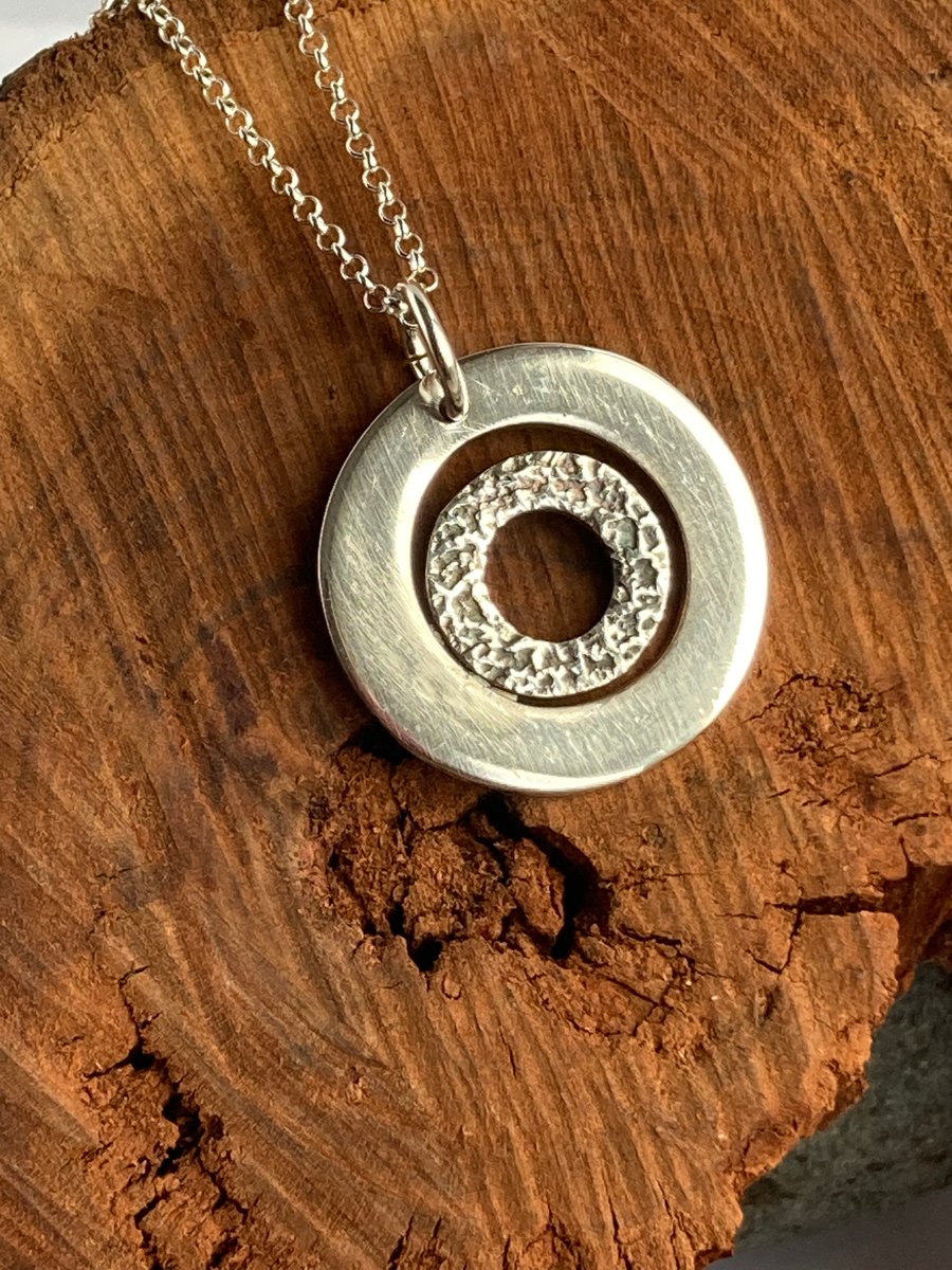 Circle within a circle fine silver pendant