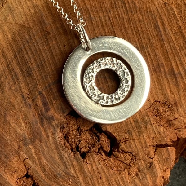 Circle within a circle fine silver pendant