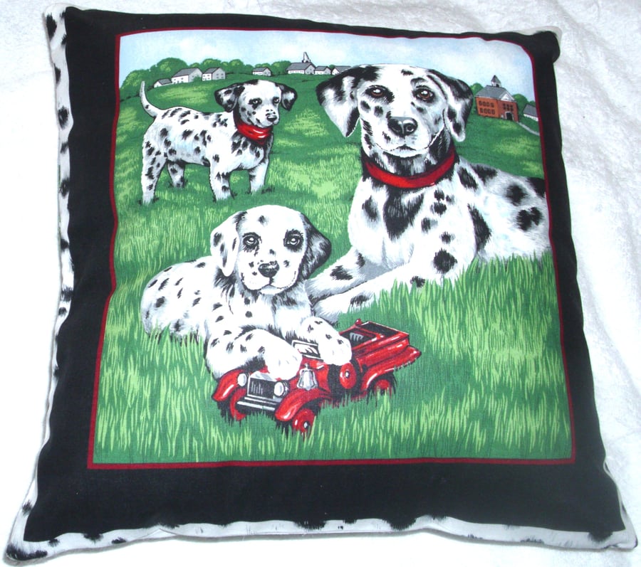 A Dalmation and young pups in the park cushion