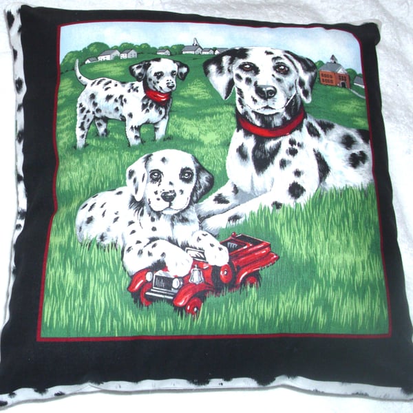 A Dalmation and young pups in the park cushion