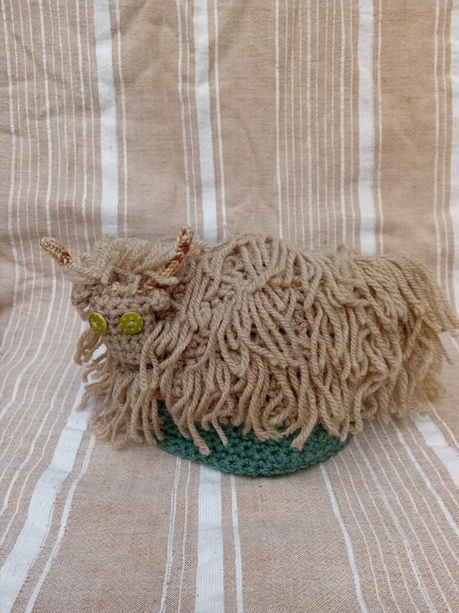 Crocheted Highland cow tea-cosy 
