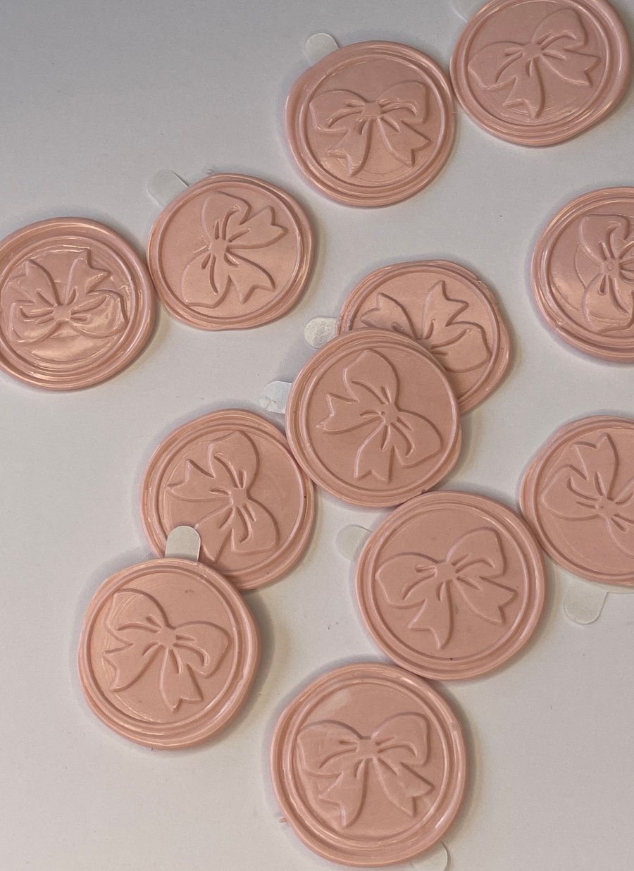 12 Wax seals in a pale peachy pink with bow decoration.