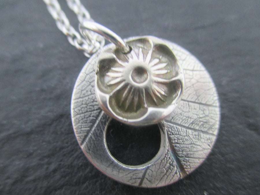 Silver flower and leaf disc pendant