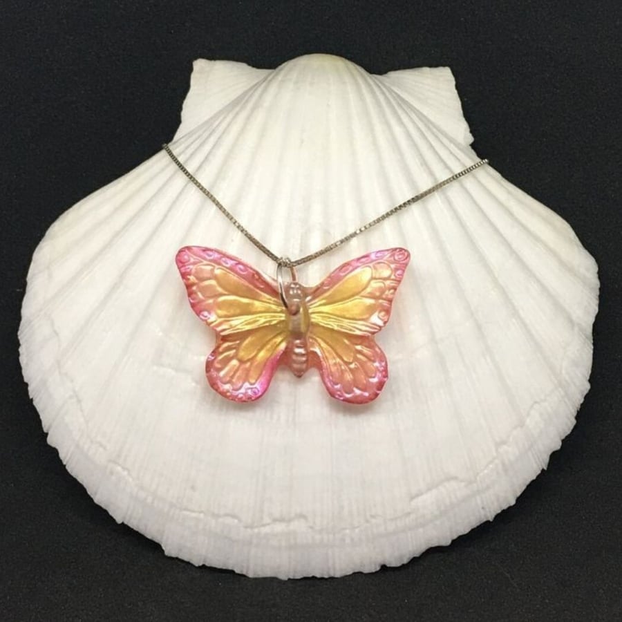 Pink and orange butterfly hand painted resin pendant on sterling silver chain.
