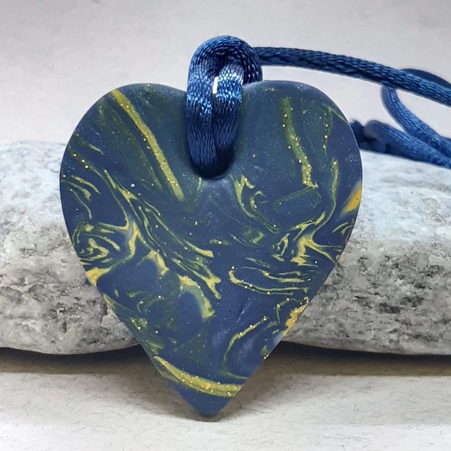 Polymer clay heart shaped pendant with a touch of sparkle