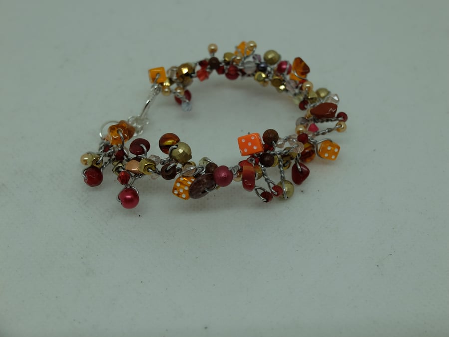 Hand made beaded bracelet with orange dice beads