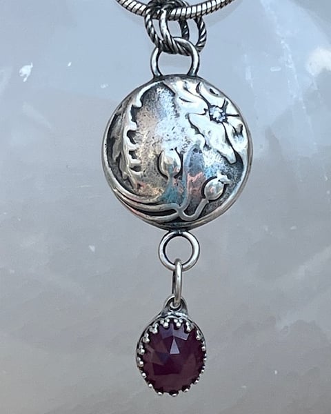 Silver poppy pendant with ruby
