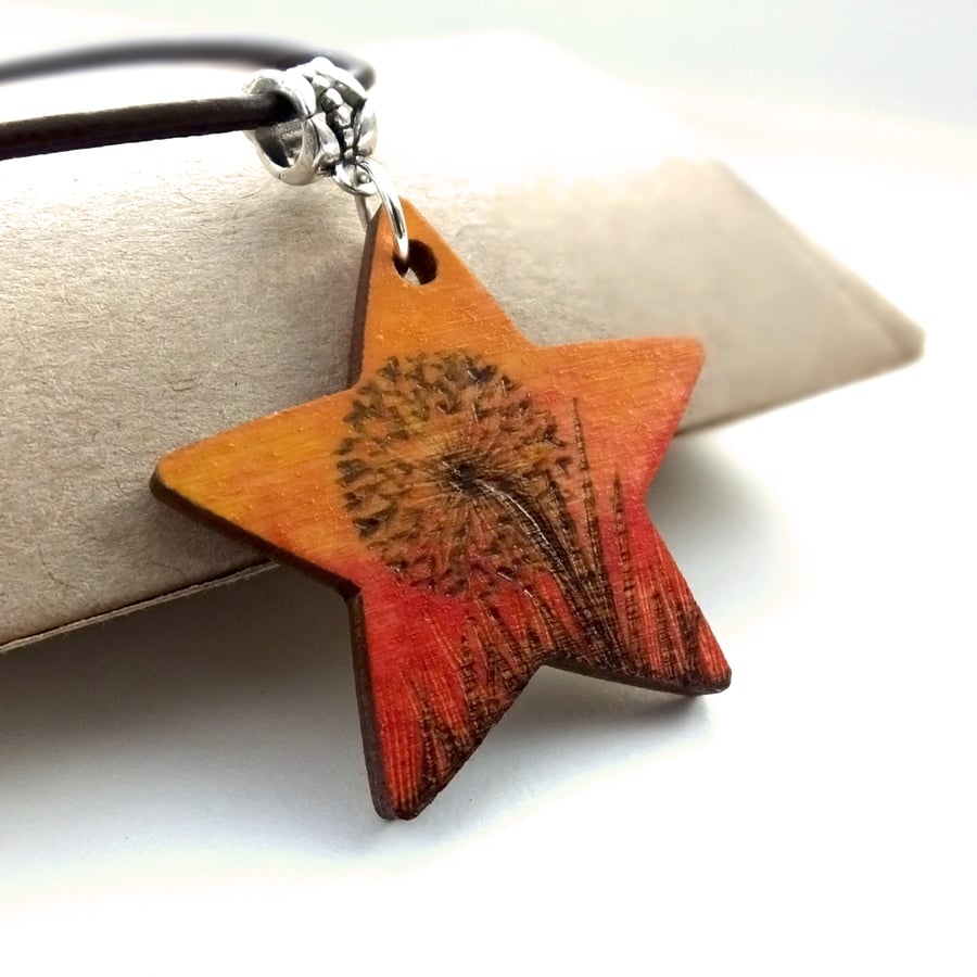Pyrography star pendant, with a dandelion clock at sunset. Wood Necklace.