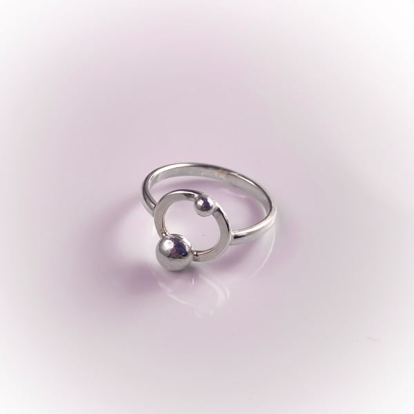 Silver ring with orbiting pebbles