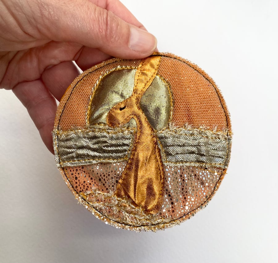 Upcycled embroidered harvest hare home decoration. 