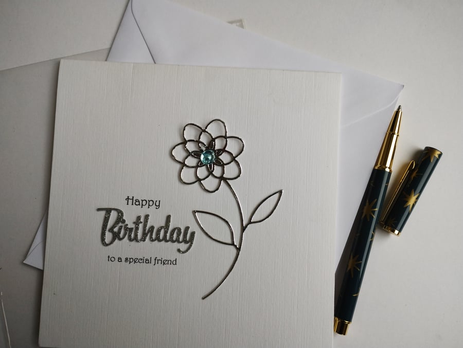 Happy Birthday to a special friend - silver flower with blue dew drop centre 