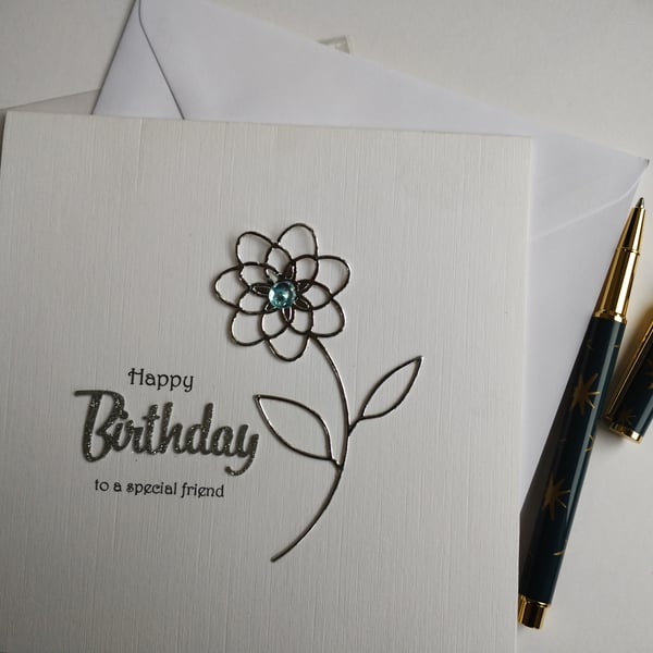 Happy Birthday to a special friend - silver flower with blue dew drop centre 