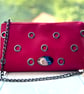 Shoulder bag in Red faux leather with eyelets and chain strap 