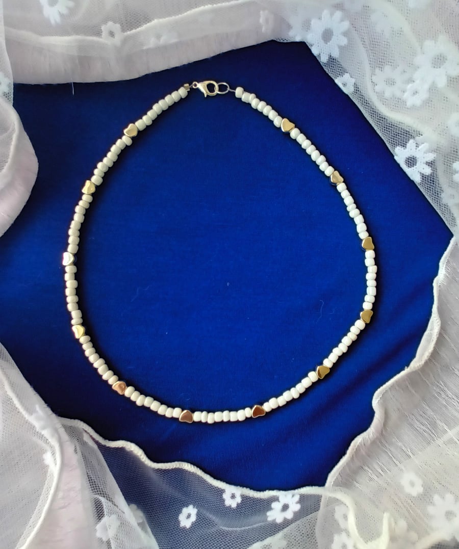 Pretty  and Dainty seed pearl necklace with silver coloured hearts