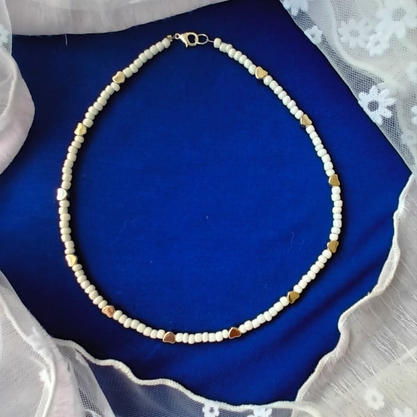 Pretty  and Dainty seed pearl necklace with silver coloured hearts