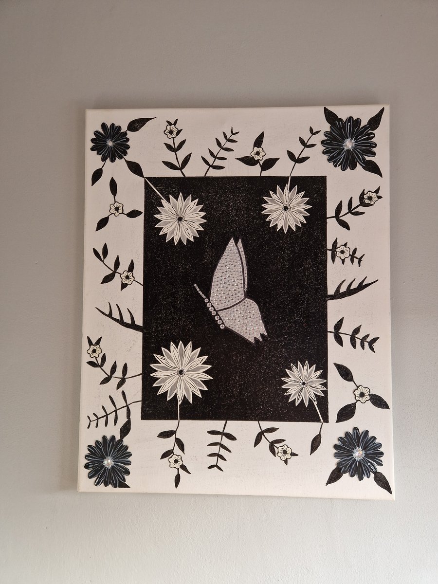 Black and white flowers and sequinned butterfly picture on canvas. 