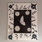 Black and white flowers and sequinned butterfly picture on canvas. 
