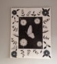 Black and white flowers and sequinned butterfly picture on canvas. 