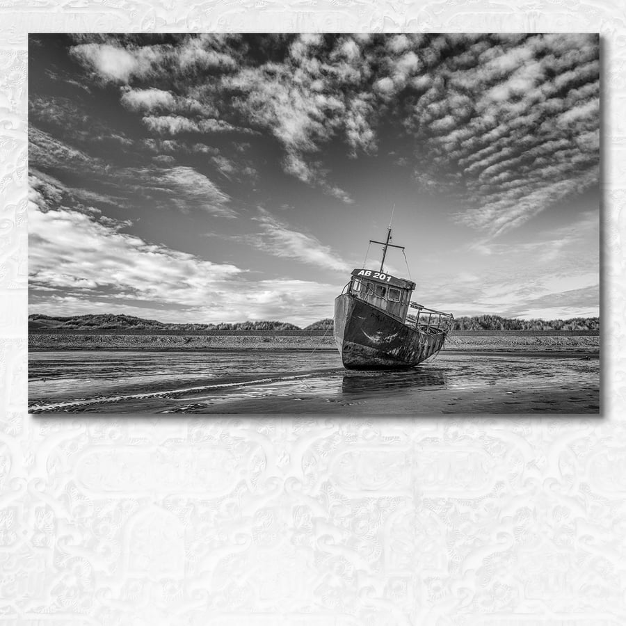 Beached fishing boat at Barmouth in black and white. Gwynedd, Wales.