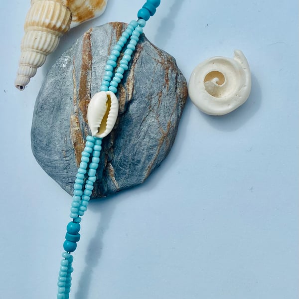 Aquamarine Glass Bead & Cowrie Shell Bracelet with Sterling Silver Detail.