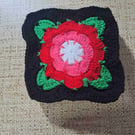 Red and pink flower block with black boarder granny square