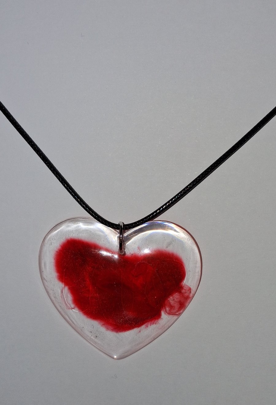 Handmade resin red heart pendant on  black waxed cord