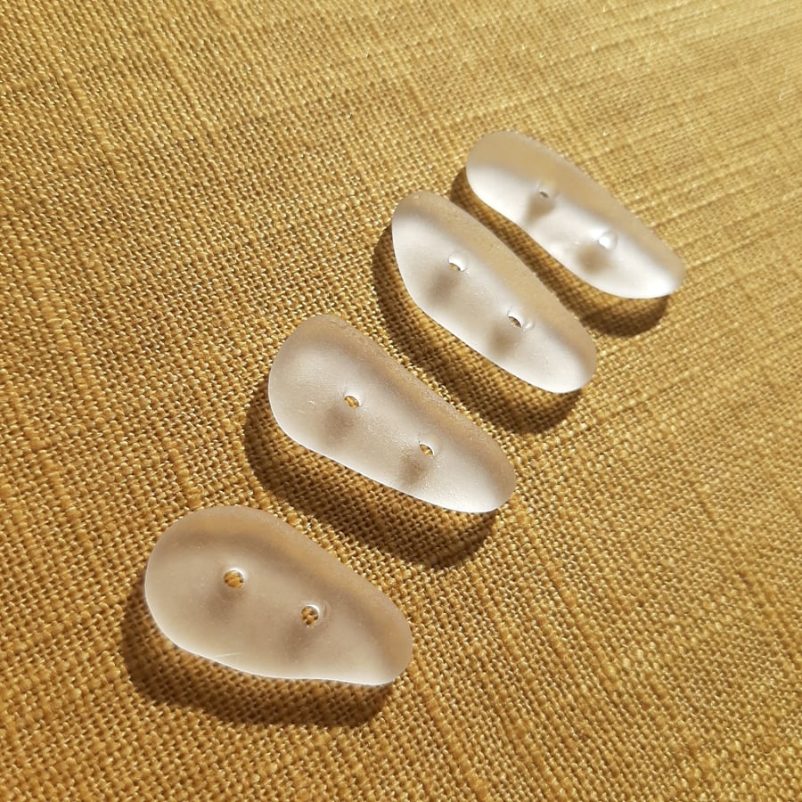Four frosted clear sea glass buttons