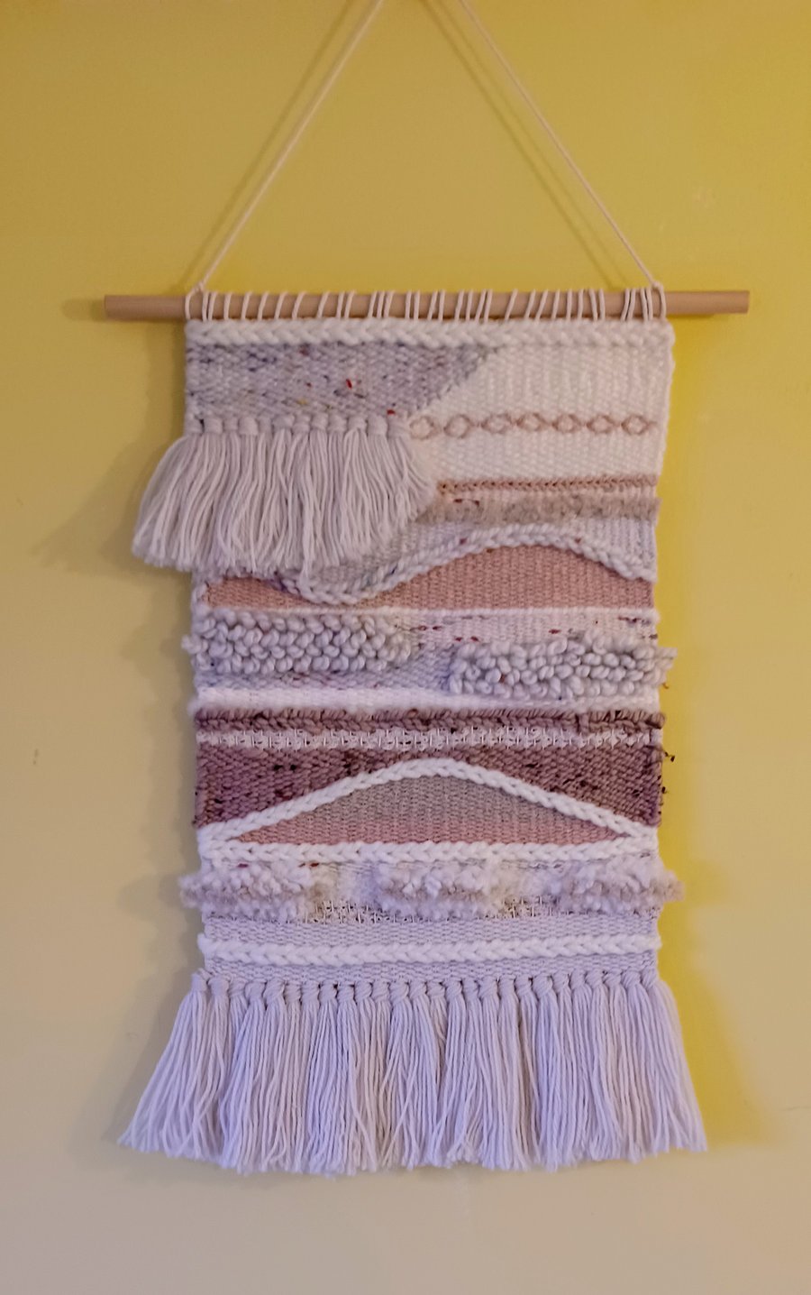 Abstract handwoven wall hanging in cream and pinks